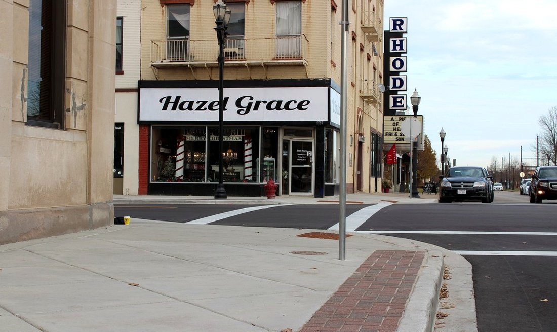 Rebuilt corner storefront intersection with ADA hardscape on the 6th Avenue corridor