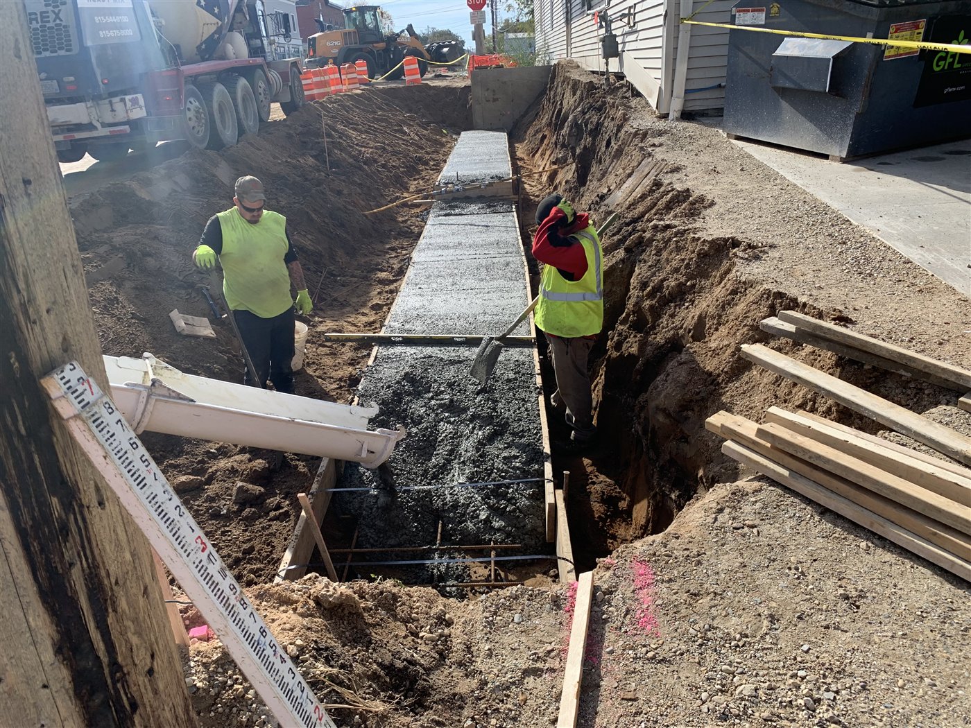 Crews placing concrete for a cast-in-place retaining wall along Church Street