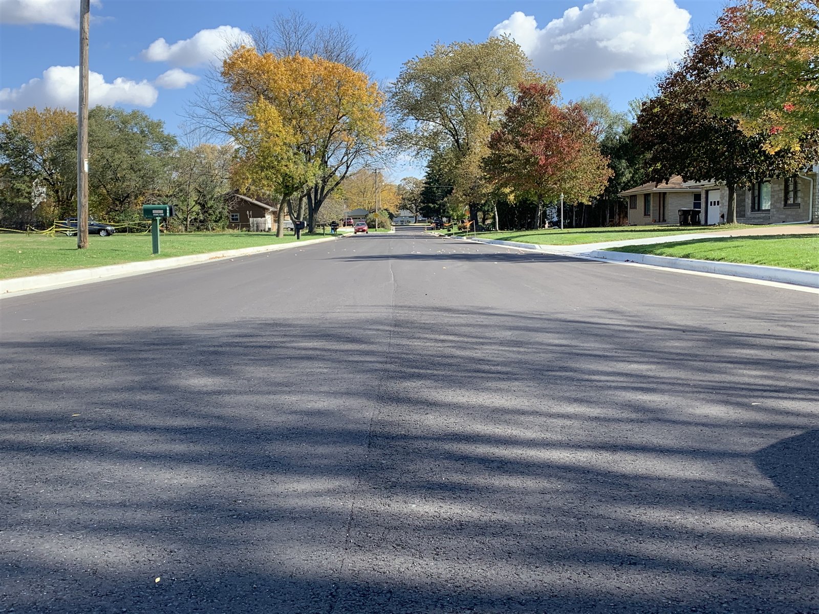 Finished Clayton Avenue with new asphalt, curb, and terrace restoration