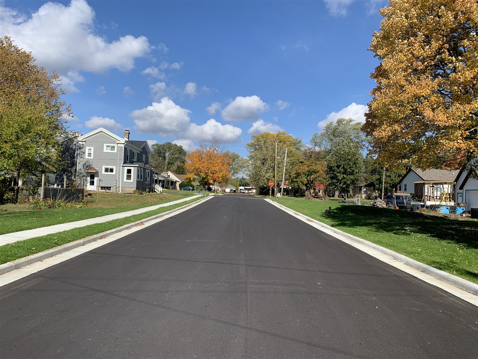 New pavement, curb and gutter, and walks on the finished neighborhood street