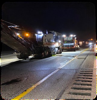 Milling train at work under portable lighting in the closed lane