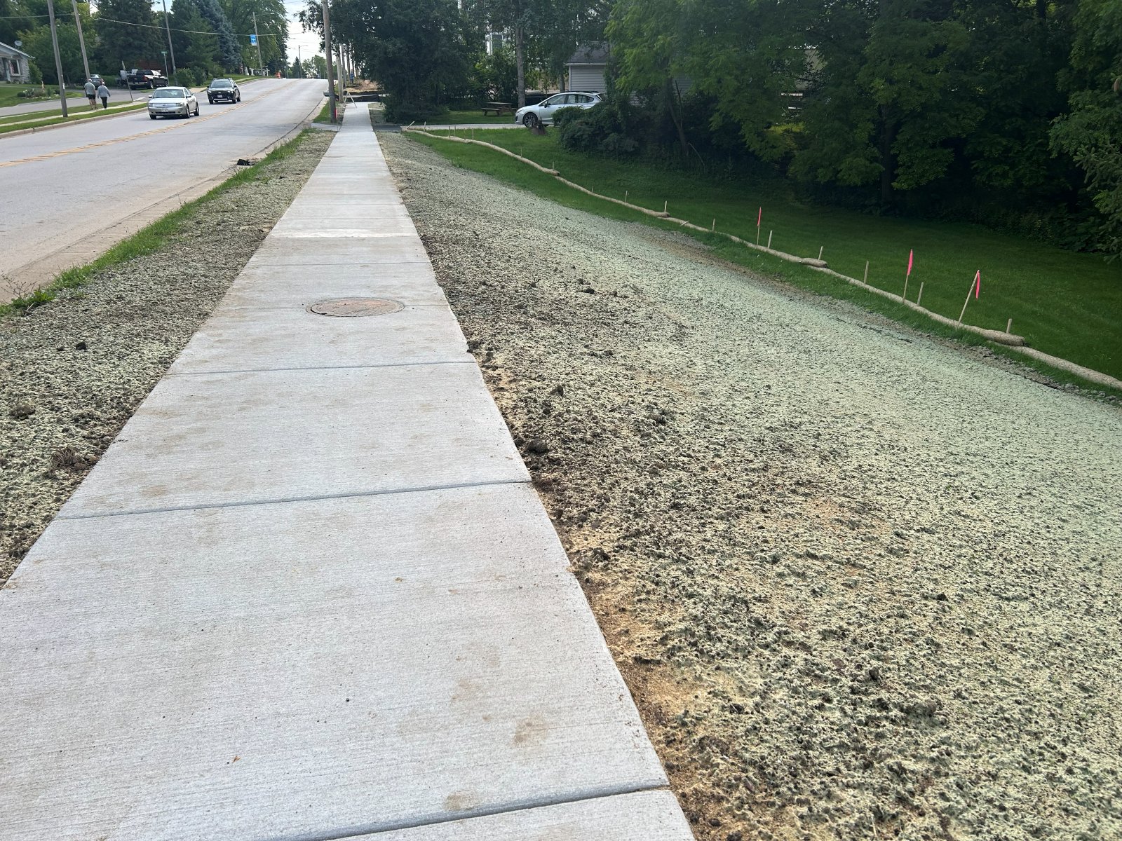 New concrete sidewalk extending along Main Street in East Troy with hydroseeded terrace