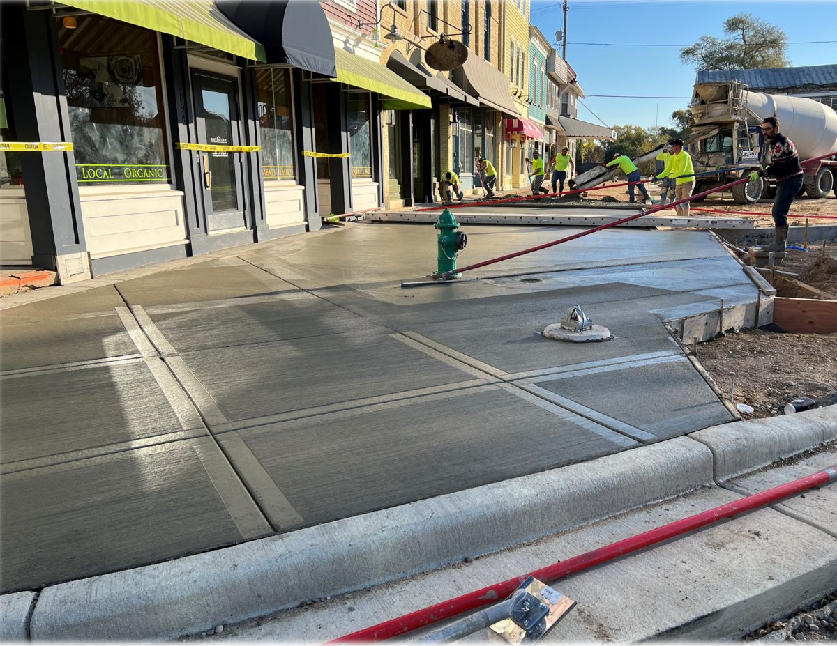 Concrete crews finishing ADA-compliant hardscape on the square