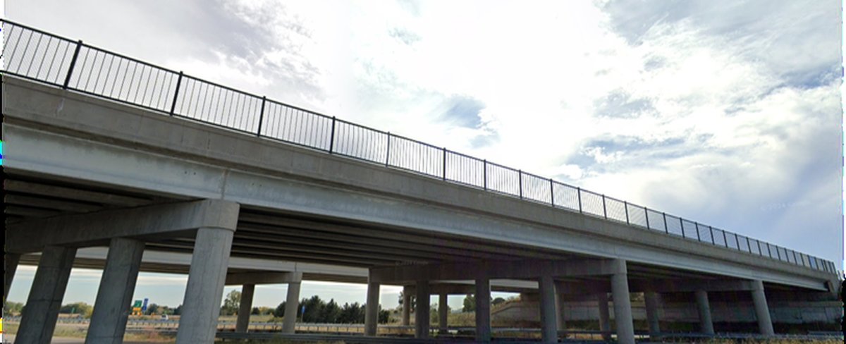 Completed USH 12 bridge carrying traffic over the local roadway
