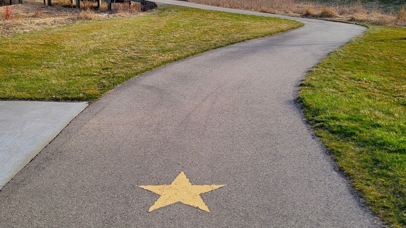 Gold star pavement marking on the paved Gold Star Memorial Trail
